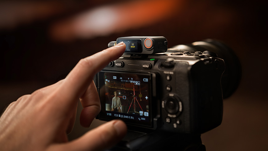 Nadajnik DJI Mic 3 czarny grafika przedstawia aparat nagrywający osobę na scenie